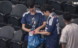 Japanese fans clean the stadium after a draw with the Netherlands in the World Cup.