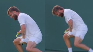 Corentin Moutet breaks his racket and gives it to a fan after losing at Wimbledon.