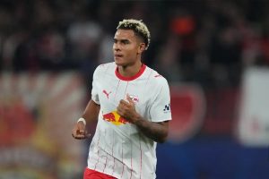 Antonio Nusa in RB Leipzig's white and red kit, looking ahead during a Champions League match.