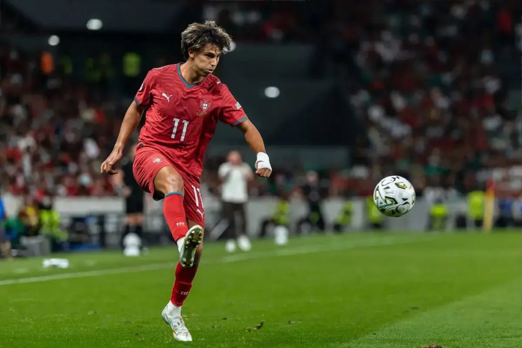 Joao Felix in red Portugal kit, number 11, dribbling the ball during a match in a stadium